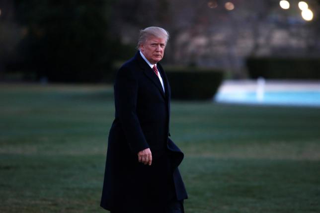 Tổng thống Mỹ Donald Trump bước vào Nhà Trắng sau khi xuống máy bay Marine One ngày 27/3 - Ảnh: Reuters.