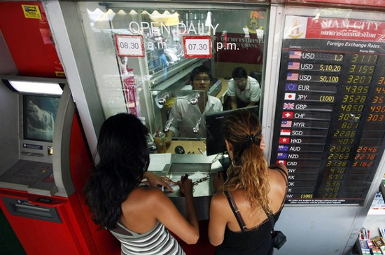 Khách du lịch đang đổi tiền ở Pg88 com chính chủ tại Bangkok, Thái Lan - Ảnh: Reuters.