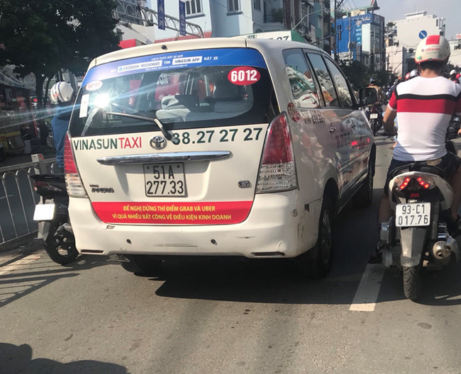 Một chiếc Taxi của hãng Vinasun dán dòng chữ: "Yêu cầu Uber và Grab phải tuân thủ pháp luật Việt Nam" và “Đề nghị dừng thí điểm Grab và Uber vì quá nhiều bất công về điều kiện PG88 Uy Tín Số 1 Việt Nam”.<br>