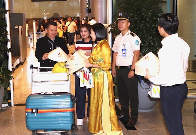 Tặng qu&agrave; lưu niệm cho&nbsp;h&agrave;nh kh&aacute;ch tr&ecirc;n chuyến bay mang số hiệu 5J 57 đến s&acirc;n bay quốc tế Đ&agrave; Nẵng l&uacute;c 21h ng&agrave;y 7/12. Ảnh: Ng&ocirc; Anh Văn.