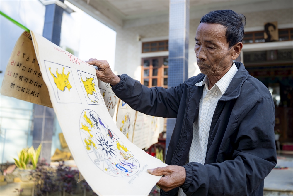 Nghệ nhân Kỳ Hữu Phước phơi tranh dân gian làng Sình.