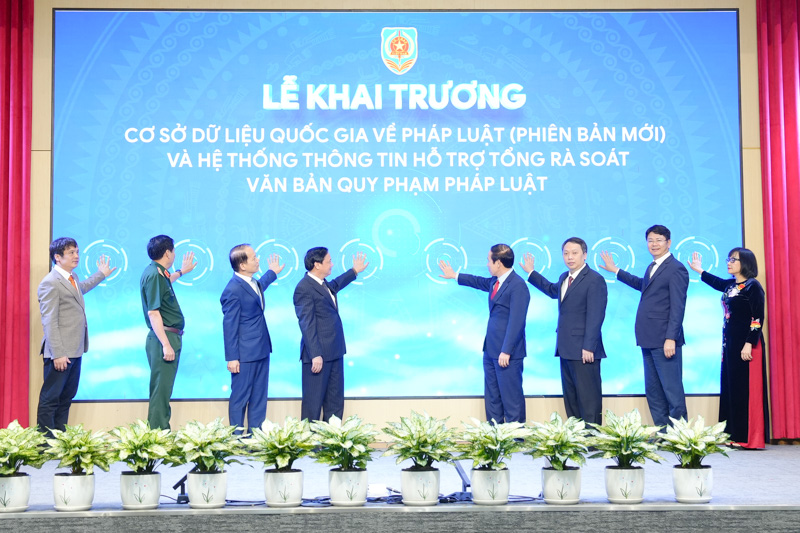 Các đại biểu thực hiện nghi thức bấm nút khai trương Cơ sở dữ liệu quốc gia về pháp luật (phiên bản mới) và Hệ thống thông tin hỗ trợ tổng rà soát văn bản quy phạm pháp luật. Ảnh: MOJ.